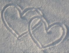 two hearts are drawn in the snow