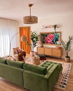 a living room filled with furniture and a large painting hanging on the wall above it