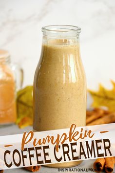 pumpkin coffee creamer in a glass jar next to cinnamon sticks