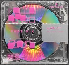 a cd that is sitting on top of a plastic case with pink and green designs