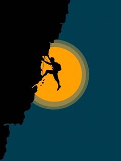 a man climbing up the side of a mountain at night