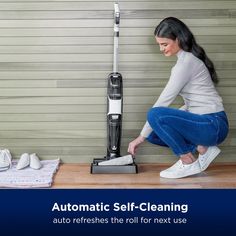 a woman is cleaning the floor with an automatic self - cleaning vacuum and mop