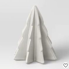 a white ceramic christmas tree on a gray background