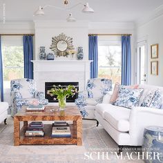 a living room filled with furniture and a fire place in front of a white fireplace