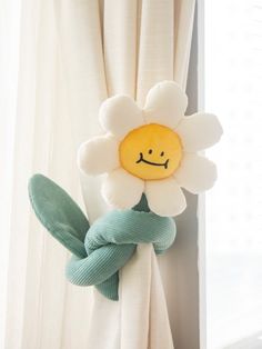 a stuffed flower with a smiling face on it