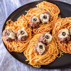 an overhead view of spaghetti with meatballs and mushrooms on it, ready to be eaten