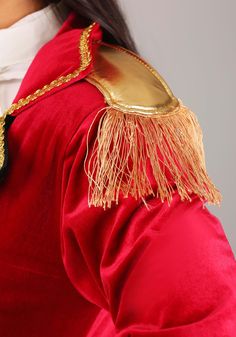 a close up of a person wearing a red coat with gold trimmings on it