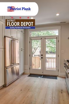 an empty kitchen with white cabinets and stainless steel appliances in front of a door that says district floor depot