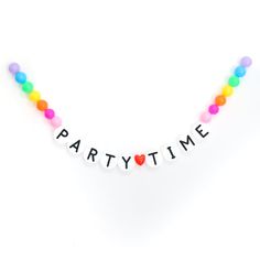 the party time sign is made out of plastic beads and has heart shaped balloons on it