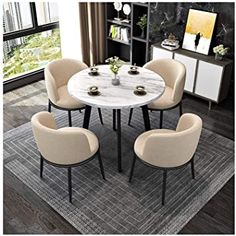 a dining room table with chairs around it and a rug on the floor next to it