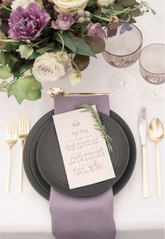 a table setting with place settings, napkins and silverware