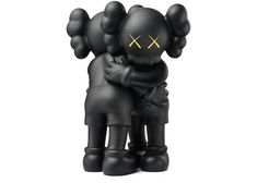 a couple of black statues sitting next to each other on top of a white surface