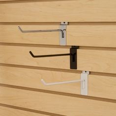 two metal hooks on the side of a wooden building