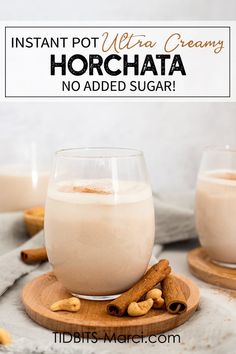 two glasses of horchata with cinnamon sticks on the side