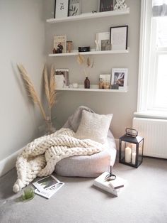 a living room filled with lots of furniture and books on top of a white shelf