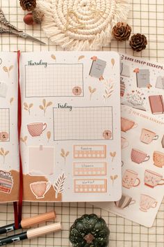 the contents of a planner spread out on a table with pine cones and other items