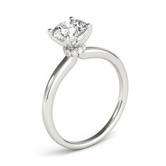 a white gold engagement ring with a single diamond in the center, on a white background