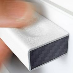 a close up of a white door handle with a black checkerboard on it