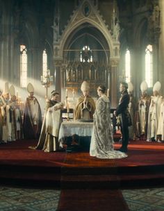 a group of people standing in front of a church alter with priest and other priests