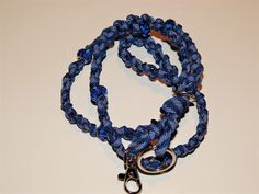 This lanyard has MANY uses! Stand out and make a statement at your work or your next meeting or conference with this one of a kind beaded name badge or ID neck lanyard! The Lanyard is woven 550 seven strand paracord and intertwined with various style beads. The paracord is durable, light weight, and soft and continues to get softer with wear. Extending from the base are two loops with a silver swivel spring clip to hold your name badge or belongings and a split key ring for additional items such Blue Lanyard With Key Leash For Personal Use, Blue Lanyards With Key Leash As Gift, Blue Lanyard With Key Leash For Gift, Blue Lanyard With Key Leash As Gift, Handmade Blue Lanyards For Gifts, Handmade Blue Lanyards As Gifts, Handmade Blue Lanyard As Gift, Lanyard Blue, Id Lanyard