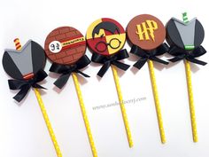 four lollipops with harry potter designs on them