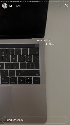 an open laptop computer sitting on top of a white desk next to a mouse and keyboard