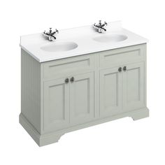 the double sink vanity has two faucets on it's sides and is painted white