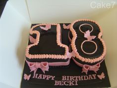 a black and pink birthday cake with the number twenty five on it's side