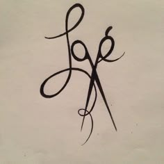 a pair of scissors sitting on top of a piece of paper with the word love written in cursive writing