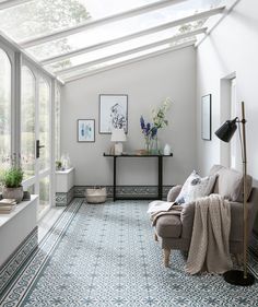 a living room filled with furniture and lots of windows next to a window sill