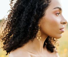 Elevate your boho chic style with these beautiful elegant Yellow Glass and Gold Filigree Drop Earrings! Add a touch of radiance and enchantment to any ensemble with these gorgeous beaded long gold earrings. The sparkling yellow champagne-colored glass teardrop shaped beads, accented by shimmery white glass beads and intricate bright gold-plated filigree add elegant eye-catching sparkle to your look. Measuring 2.75 inches, these long, dangling yellow earrings are sure to catch attention. Don't mi Gold Beaded Drop Earrings, Gold Bohemian Beaded Earrings With Ear Wire, Bohemian Gold Beaded Earrings With Ear Wire, Gold Bohemian Chandelier Earrings With Dangling Beads, Delicate Gold Beaded Earrings, Elegant Festival Earrings With Dangling Beads, Bohemian Gold Linear Earrings With Ear Wire, Bohemian Beaded Drop Bridal Earrings, Elegant Beaded Earrings For Festival