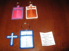 three crocheted items on a table with a note attached to the keychain