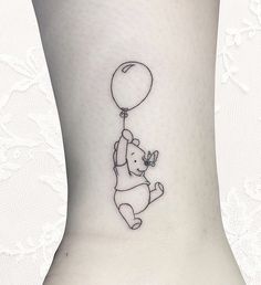 an elephant with a balloon tattoo on the ankle is flying through the air while holding it's tail