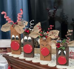 some brown bags with red noses and nose decorations on top of a wooden table in front of a window