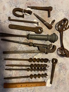 an assortment of old tools are laid out on a table