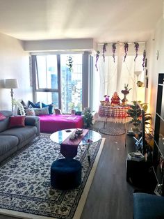 a living room filled with furniture and a large window