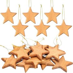 several wooden stars hanging from strings on a white background