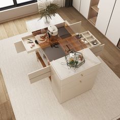 an aerial view of a living room and dining room area with white furniture, beige rugs and large windows