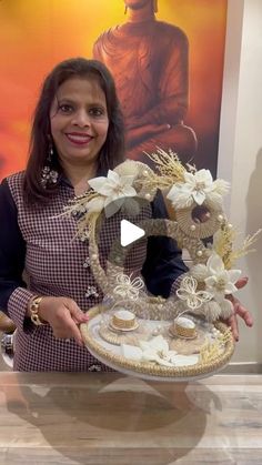 a woman holding a tray with cupcakes on it