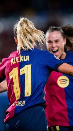 two female soccer players are celebrating their team's victory