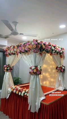 the bed is decorated with flowers and white drapes