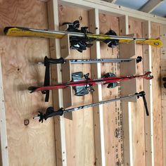 there are many skis and poles on the wall in this room that is being built