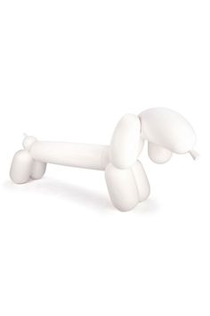 a white balloon dog laying on its back with it's tail extended to the ground