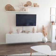 a flat screen tv sitting on top of a white entertainment center