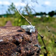 a wedding ring sitting on top of a rock