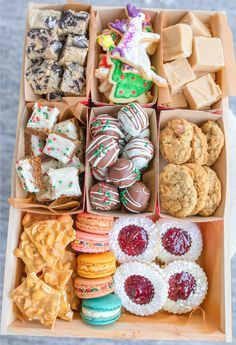 a box filled with lots of different types of cookies and pastries on top of a table