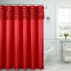 a red shower curtain in a white bathroom