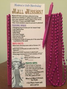 a pink birthday card with beads and a pen on it next to a notepad