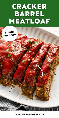 a white plate topped with meatloaf covered in sauce