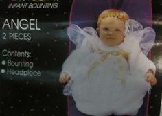 a baby doll in a white angel costume